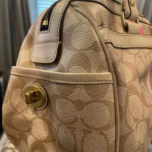 Cream/pink colored Coach satchel bag.